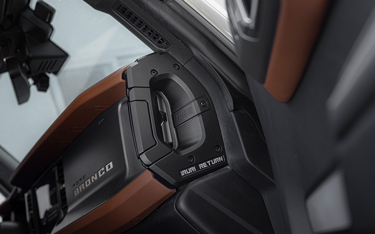 A pair of black, textured IRURI Center Console Side Grab Handles for the Ford Bronco, featuring the '1966' and 'IRURI RETURN' branding, displayed as an interior upgrade accessory.