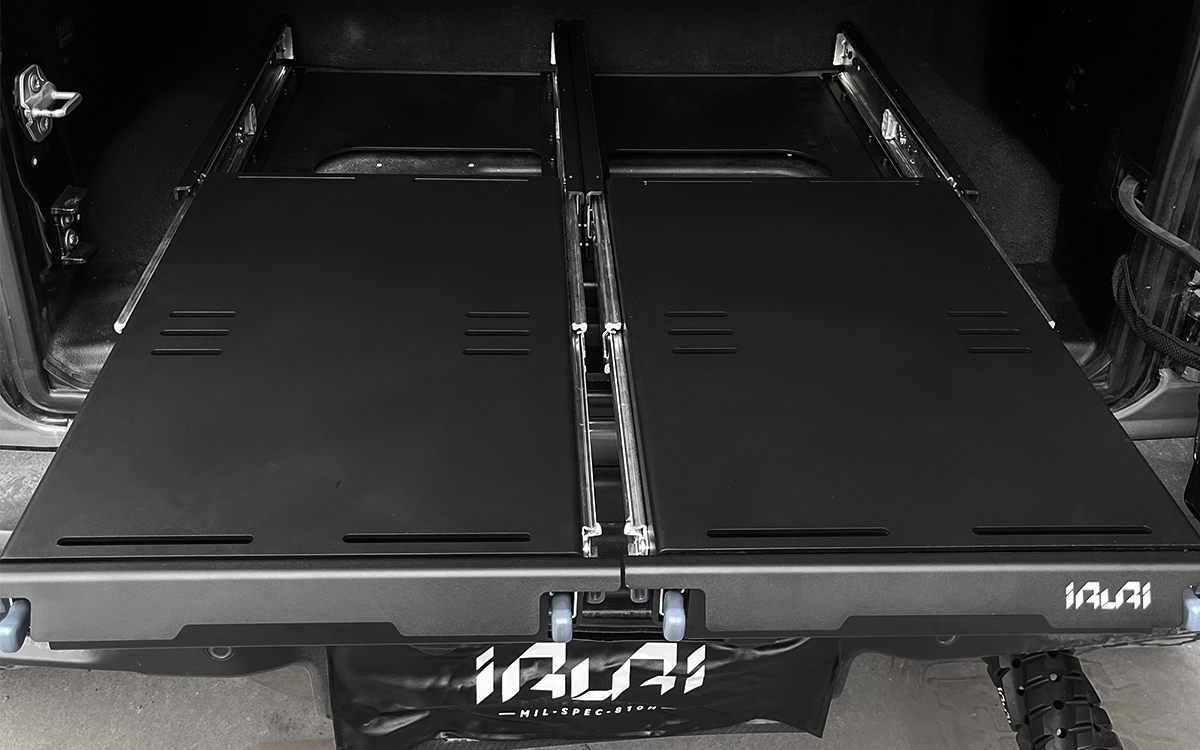 Studio isometric view of IRURI low-profile dual drawer storage system extended on ball-bearing slides.