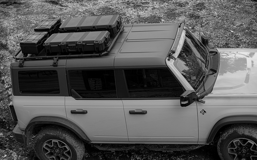 Premium 2021-2026 Ford Bronco roof rack platform. Low-profile aerodynamic design reduces wind noise. Modular no-drill cargo system for overland gear.