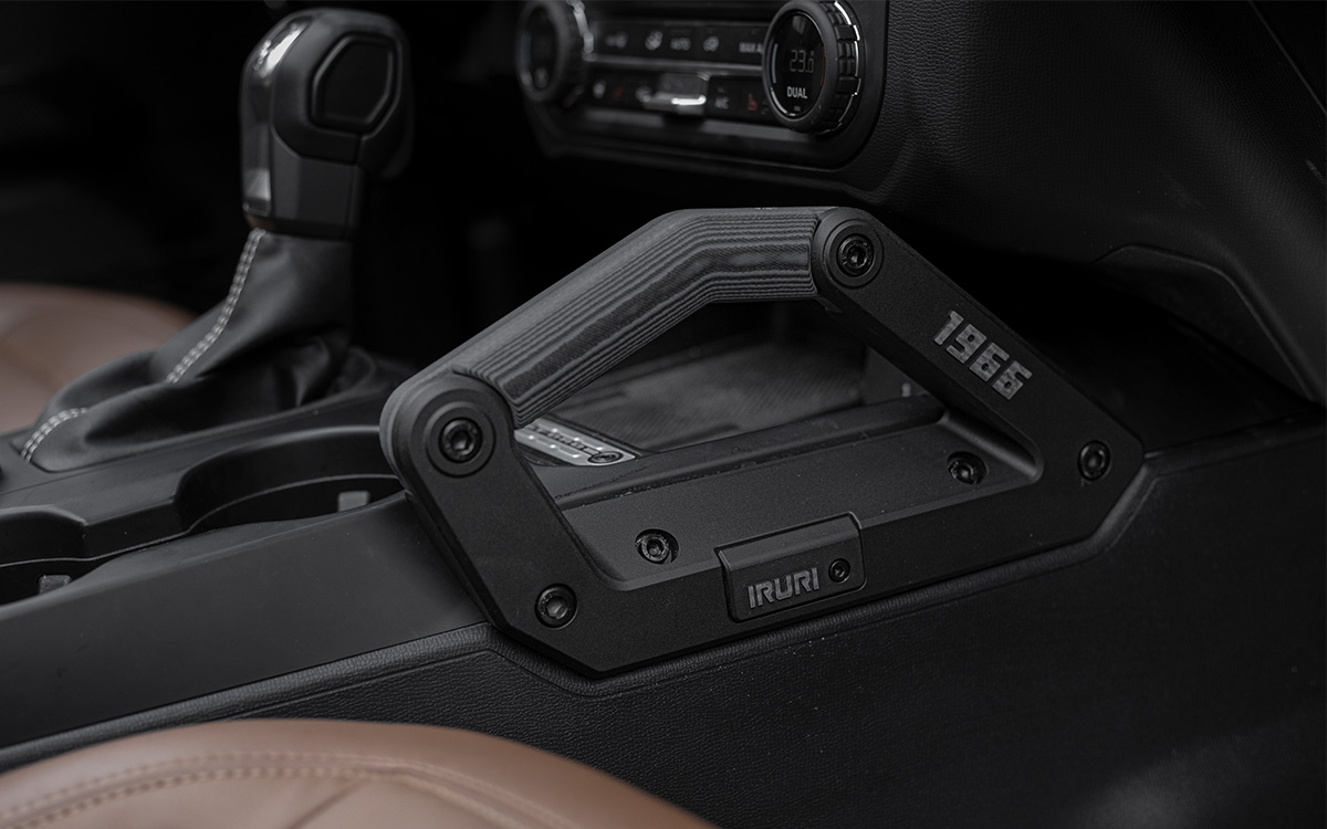 Close-up architectural view of the contoured wedge profile of the direct-replacement Bronco center console armrest.