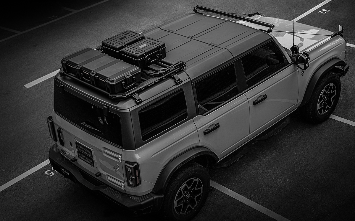 Ultimate overlanding utility. 2021-2026 Ford Bronco tactical folding roof rack platform. Heavy-duty design with noise-reducing folding mechanism. No-drill fit.